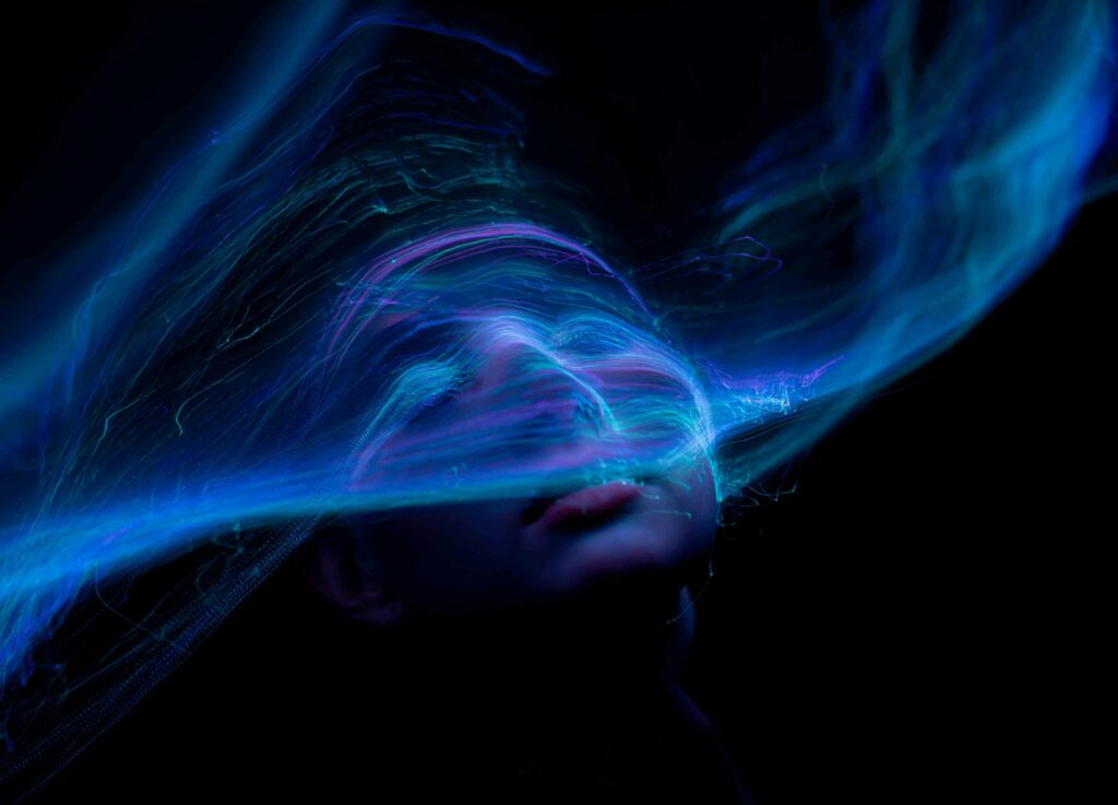 pexels-photo-11167645-11167645 Dynamic portrait with swirling neon lights creating an ethereal and futuristic vibe.